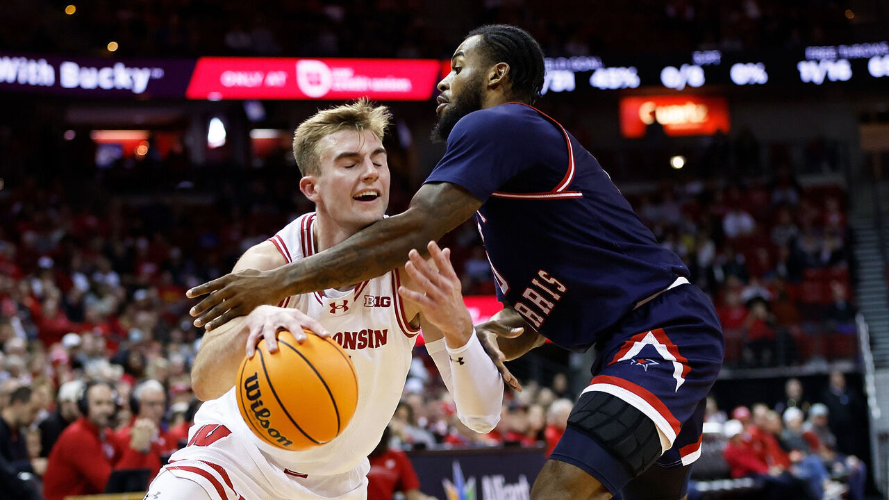 MADISON, WISCONSIN - NOVEMBER 17: Tyler Wahl #5 of the Wisconsin Badgers is fouled going to the basket by Markeese Hastings #0 of the Robert Morris Colonials during the second half at Kohl Center on November 17, 2023 in Madison, Wisconsin.