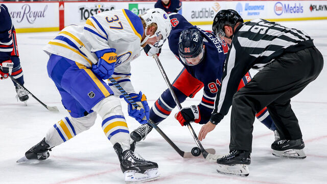 WINNIPEG, CANADA - NOVEMBER 17: Cole Perfetti #91 of the Winnipeg Jets takes a second period face-off against Casey Mittelstadt #37 of the Buffalo Sabres at the Canada Life Centre on November 17, 2023 in Winnipeg, Manitoba, Canada.