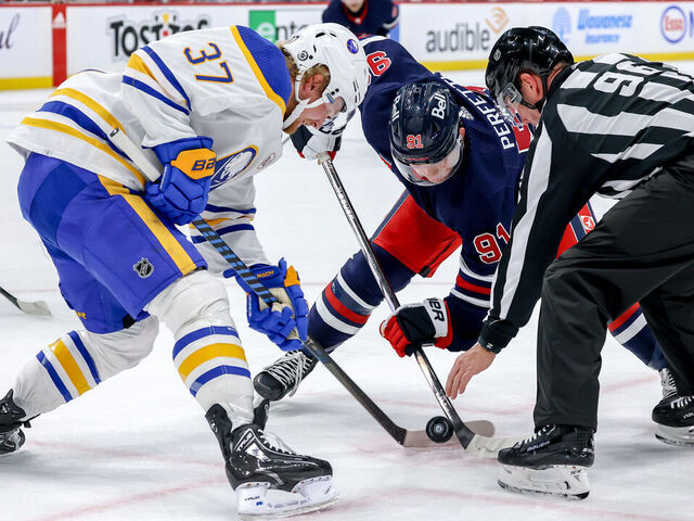 WINNIPEG, CANADA - NOVEMBER 17: Cole Perfetti #91 of the Winnipeg Jets takes a second period face-off against Casey Mittelstadt #37 of the Buffalo Sabres at the Canada Life Centre on November 17, 2023 in Winnipeg, Manitoba, Canada.