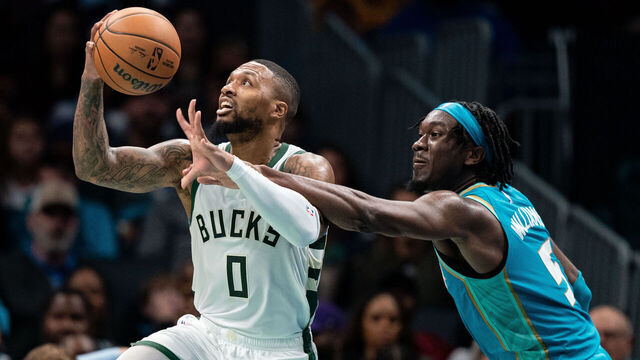 CHARLOTTE, NORTH CAROLINA - NOVEMBER 17: Damian Lillard #0 of the Milwaukee Bucks drives to the basket while guarded by Mark Williams #5 of the Charlotte Hornets in the third quarter during an NBA In-Season Tournament game at Spectrum Center on November 17, 2023 in Charlotte, North Carolina.