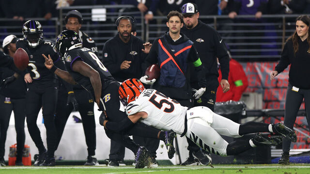 BALTIMORE, MARYLAND - NOVEMBER 16: Logan Wilson #55 of the Cincinnati Bengals tackles Lamar Jackson #8 of the Baltimore Ravens during the first quarter of the game at M&T Bank Stadium on November 16, 2023 in Baltimore, Maryland.