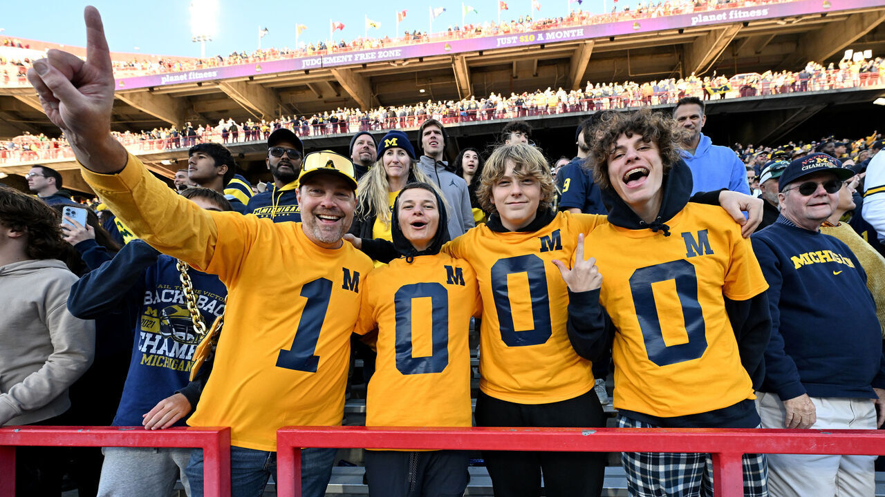 COLLEGE PARK, MARYLAND - NOVEMBER 18: Michigan Wolverines fans celebrate the 1000th win in program history after a 31-24 victory against the Maryland Terrapins at SECU Stadium on November 18, 2023 in College Park, Maryland.