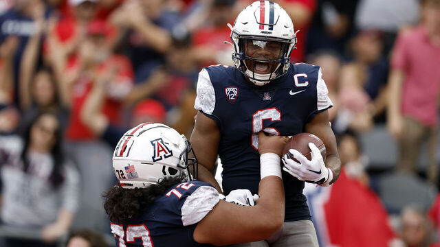 TUCSON, ARIZONA - NOVEMBER 18: Running back Michael Wiley #6 of the Arizona Wildcats reacts with offensive lineman Wendell Moe #72 after scoring a touchdown against the Utah Utes during the first half at Arizona Stadium on November 18, 2023 in Tucson, Arizona.