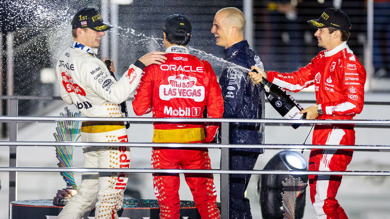 LAS VEGAS, NV - NOVEMBER 18: Ferrari driver Charles Leclerc (16) of Monaco nails Red Bull Racing driver Max Verstappen (1) of the Netherlands with champagne after the F1 Las Vegas Grand Prix on Saturday, November 18, 2023 on the Las Vegas Street Circuit in Las Vegas, NV.