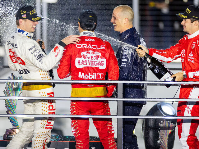 LAS VEGAS, NV - NOVEMBER 18: Ferrari driver Charles Leclerc (16) of Monaco nails Red Bull Racing driver Max Verstappen (1) of the Netherlands with champagne after the F1 Las Vegas Grand Prix on Saturday, November 18, 2023 on the Las Vegas Street Circuit in Las Vegas, NV.