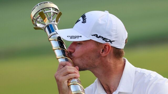 Denmark's Nicolai Hojgaard kisses the winner's trophy after the last day of the DP World Tour Championship European Tour golf tournament 2023 at Jumeirah Golf Estates in Dubai on November 19, 2023.