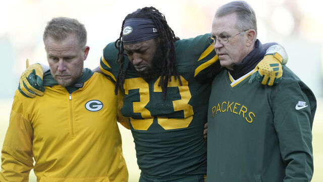 GREEN BAY, WISCONSIN - NOVEMBER 19: Aaron Jones #33 of the Green Bay Packers is helped off the field after being injured in the second quarter against the Los Angeles Chargers at Lambeau Field on November 19, 2023 in Green Bay, Wisconsin.