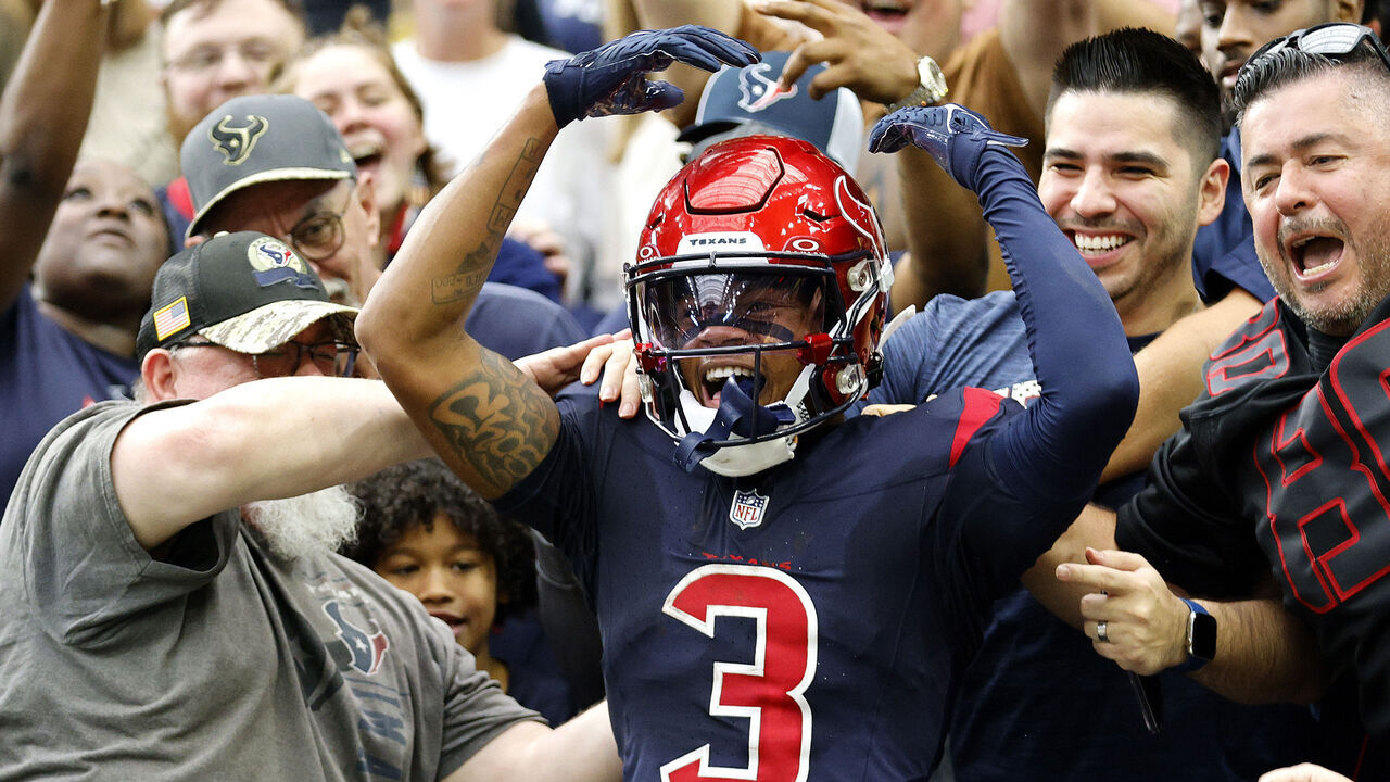 HOUSTON, TEXAS - NOVEMBER 19: Tank Dell #3 of the Houston Texans climbs into stands after a second quarter touchdown during a game against the Arizona Cardinals at NRG Stadium on November 19, 2023 in Houston, Texas.