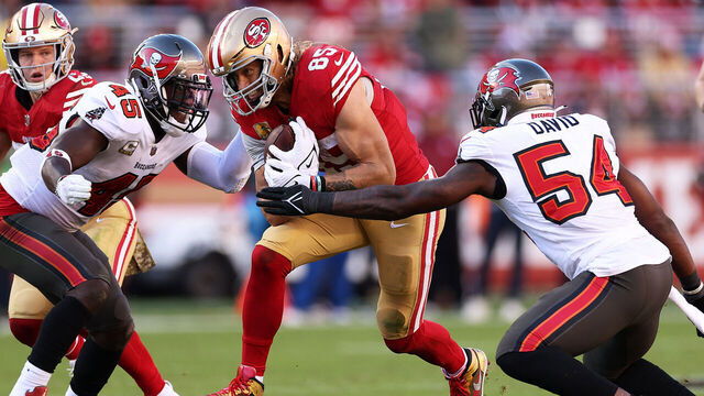 SANTA CLARA, CALIFORNIA - NOVEMBER 19: George Kittle #85 of the San Francisco 49ers looks to split Lavonte David #54 of the Tampa Bay Buccaneers and Devin White #45 of the Tampa Bay Buccaneers during the second quarter at Levi's Stadium on November 19, 2023 in Santa Clara, California.
