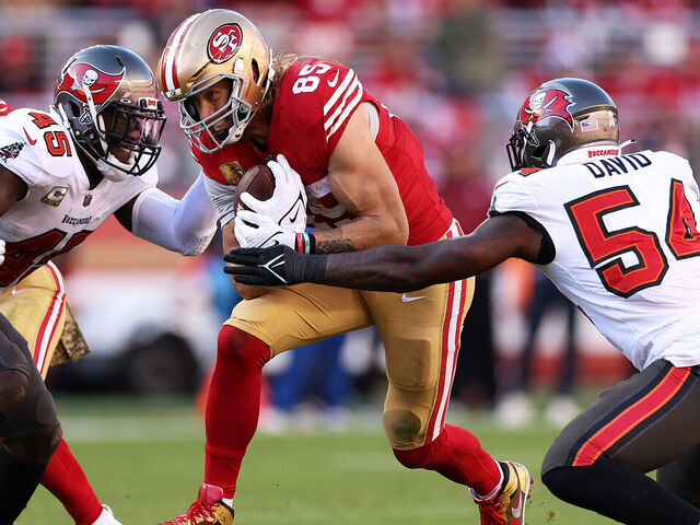SANTA CLARA, CALIFORNIA - NOVEMBER 19: George Kittle #85 of the San Francisco 49ers looks to split Lavonte David #54 of the Tampa Bay Buccaneers and Devin White #45 of the Tampa Bay Buccaneers during the second quarter at Levi's Stadium on November 19, 2023 in Santa Clara, California.