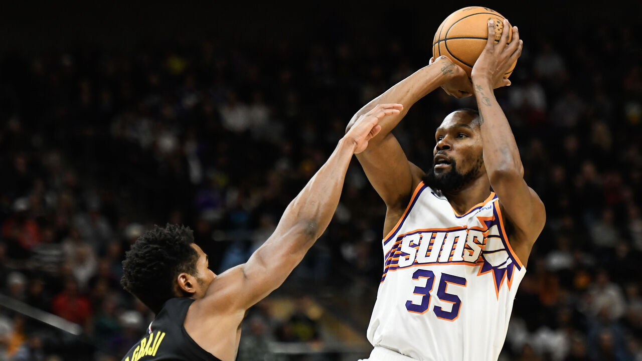 SALT LAKE CITY, UTAH - NOVEMBER 19: Kevin Durant #35 of the Phoenix Suns shoots the ball against Ochai Agbaji #30 of the Utah Jazz during the second half of a game at Delta Center on November 19, 2023 in Salt Lake City, Utah.