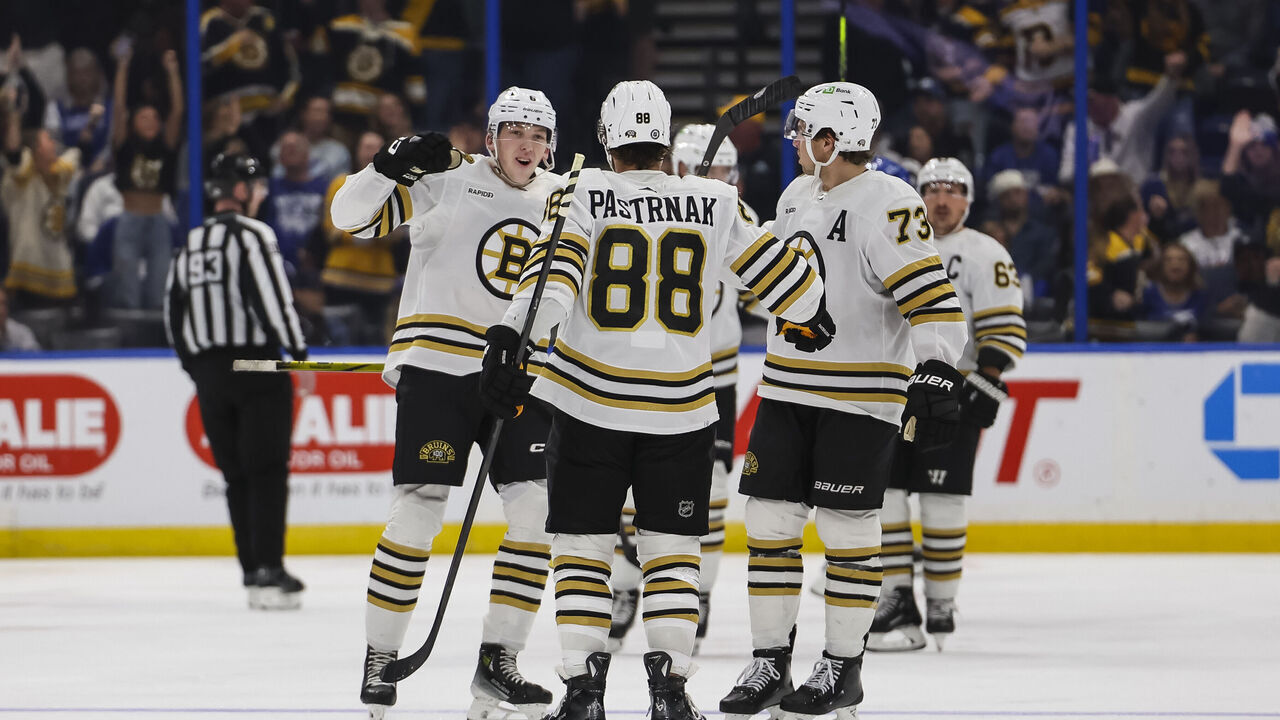 TAMPA, FL - NOVEMBER 20: David Pastrnak #88 of the Boston Bruins celebrates a goal with teammates Mason Lohrei #6 and Charlie McAvoy #73 against the Tampa Bay Lightning during the third period at Amalie Arena on November 20, 2023 in Tampa, Florida.