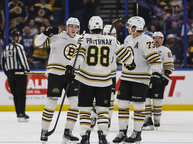 TAMPA, FL - NOVEMBER 20: David Pastrnak #88 of the Boston Bruins celebrates a goal with teammates Mason Lohrei #6 and Charlie McAvoy #73 against the Tampa Bay Lightning during the third period at Amalie Arena on November 20, 2023 in Tampa, Florida.
