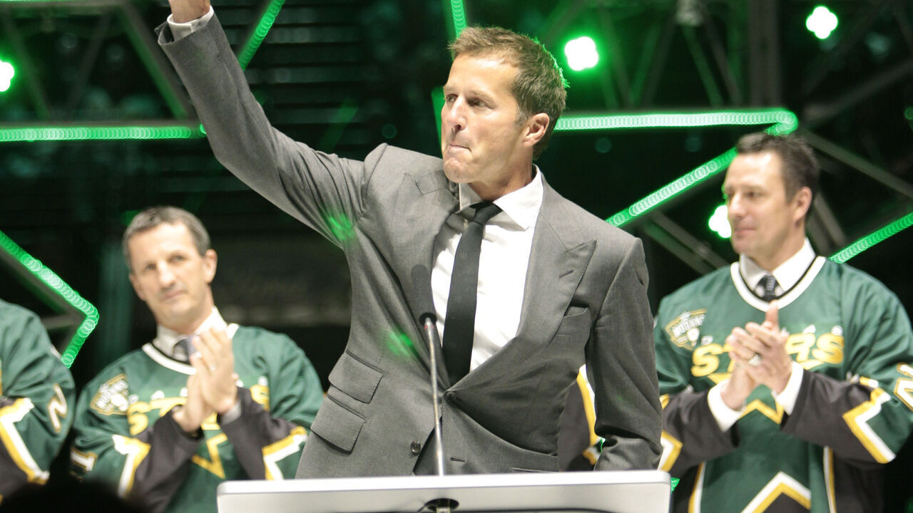 DALLAS, TX - MARCH 8: Mike Modano waves to fans during his #9 jersey retirement ceremony prior to a game against the Minnesota Wild at the American Airlines Center on March 8, 2014 in Dallas, Texas.