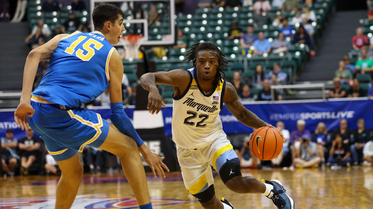 HONOLULU, HAWAII - NOVEMBER 20: Sean Jones #22 of the Marquette Golden Eagles drives past Aday Mara #15 of the UCLA Bruins during the first half of the game at SimpliFi Arena on November 20, 2023 in Honolulu, Hawaii.