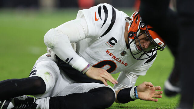 BALTIMORE, MARYLAND - NOVEMBER 16: Quarterback Joe Burrow #9 of the Cincinnati Bengals looks at his hand after throwing a pass in front of Odafe Oweh #99 of the Baltimore Ravens during the second quarter of the game at M&T Bank Stadium on November 16, 2023 in Baltimore, Maryland.