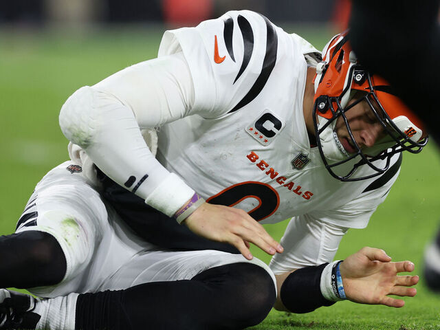BALTIMORE, MARYLAND - NOVEMBER 16: Quarterback Joe Burrow #9 of the Cincinnati Bengals looks at his hand after throwing a pass in front of Odafe Oweh #99 of the Baltimore Ravens during the second quarter of the game at M&T Bank Stadium on November 16, 2023 in Baltimore, Maryland.