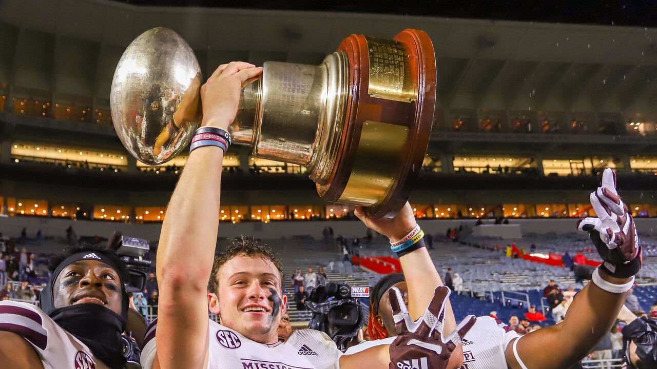 OXFORD, MS - NOVEMBER 24: Mississippi State Bulldogs quarterback Will Rogers (2), Mississippi State Bulldogs cornerback Emmanuel Forbes (13) celebrate with the Egg Bowl trophy after the game between the Ole Miss Rebels and the Mississippi State Bulldogs on November 24, 2022 at Vaught-Hemingway Stadium in Oxford, MS.