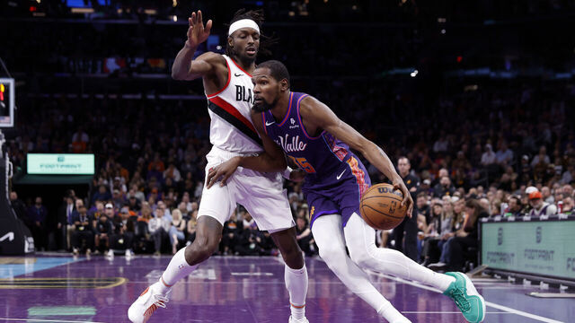 PHOENIX, ARIZONA - NOVEMBER 21: Kevin Durant #35 of the Phoenix Suns drives to the basket against Jerami Grant #9 of the Portland Trail Blazers during the second half of the NBA In-Season Tournament game at Footprint Center on November 21, 2023 in Phoenix, Arizona.