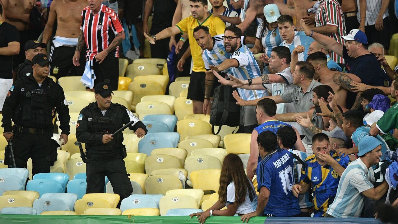 TOPSHOT - Brazilian police clash with fans of Argentina before the start of the 2026 FIFA World Cup South American qualification football match between Brazil and Argentina at Maracana Stadium in Rio de Janeiro, Brazil, on November 21, 2023.