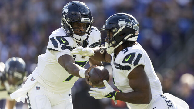 BALTIMORE, MARYLAND - NOVEMBER 05: Geno Smith #7 of the Seattle Seahawks hands off to Kenneth Walker III #9 of the Seattle Seahawks during an NFL football game between the Baltimore Ravens and the Seattle Seahawks at M&T Bank Stadium on November 05, 2023 in Baltimore, Maryland.