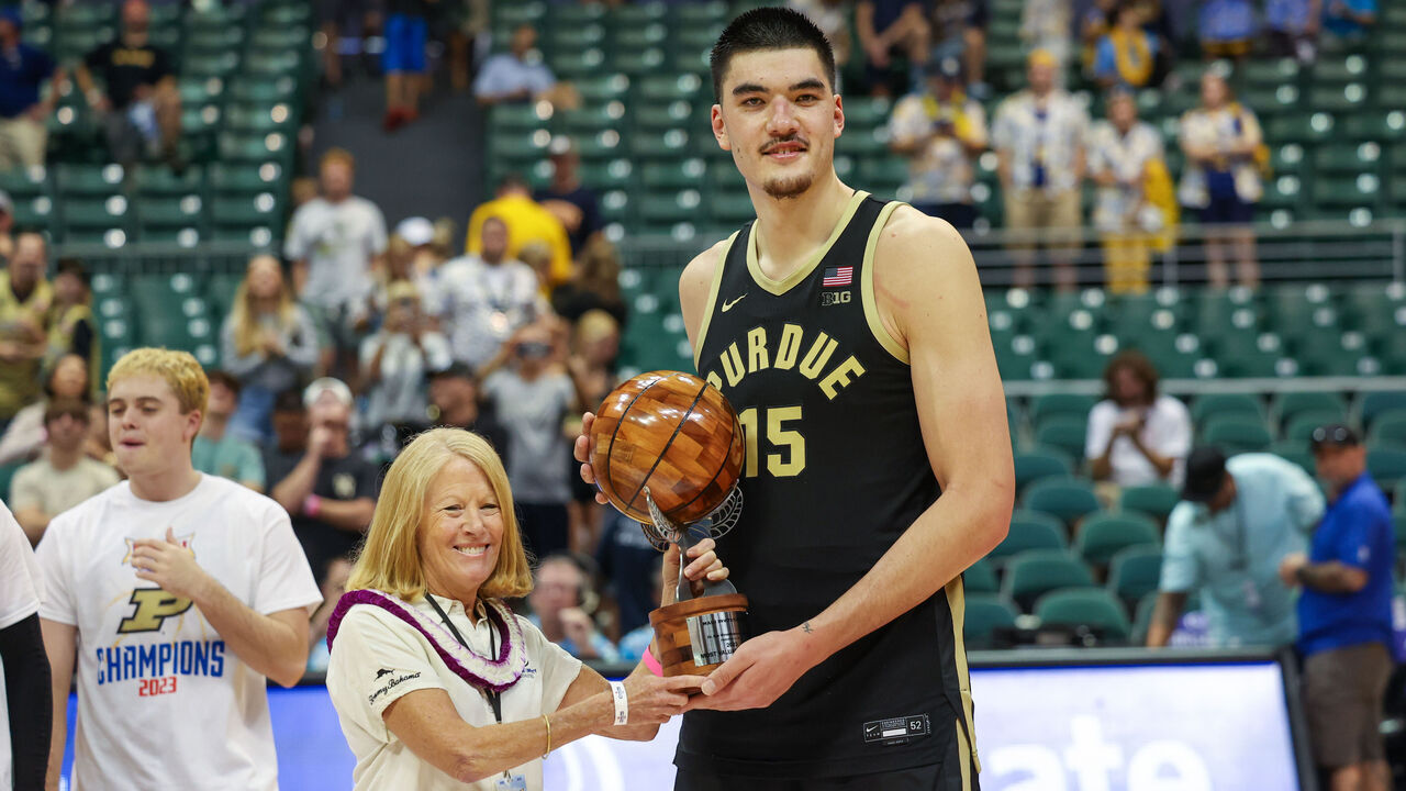 HONOLULU, HAWAII - NOVEMBER 22: Zach Edey #15 of the Purdue Boilermakers poses with Lynn Babington, the president of Chaminade University, after winning the MVP trophy at the Allstate Maui Invitational at SimpliFi Arena on November 22, 2023 in Honolulu, Hawaii.