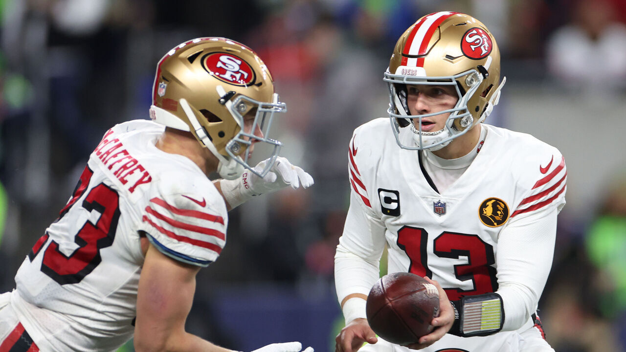 SEATTLE, WASHINGTON - NOVEMBER 23: Brock Purdy #13 of the San Francisco 49ers hands off the ball to Christian McCaffrey #23 of the San Francisco 49ers during the second quarter against the Seattle Seahawks at Lumen Field on November 23, 2023 in Seattle, Washington.