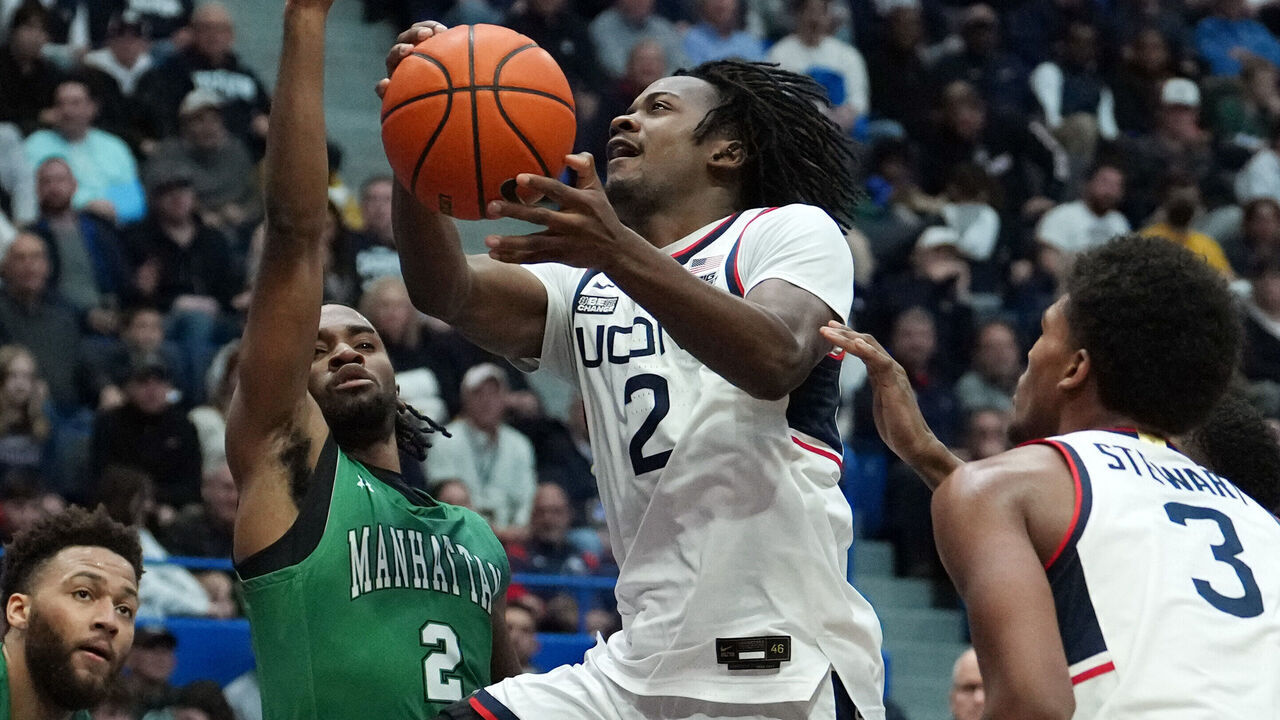 HARTFORD, CONNECTICUT - NOVEMBER 24: Tristen Newton #2 of the Connecticut Huskies drives to the rim against Jaden Winston #2 of the Manhattan Jaspers during the second half of an NCAA basketball game at the XL Center on November 24, 2023 in Hartford, Connecticut. The Huskies defeated the Jaspers 90-60.