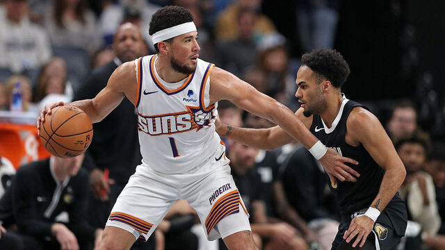 MEMPHIS, TENNESSEE - NOVEMBER 24: Devin Booker #1 of the Phoenix Suns handles the ball against Jacob Gilyard #0 of the Memphis Grizzlies during the second half during an In-Season Tournament game at FedExForum on November 24, 2023 in Memphis, Tennessee.