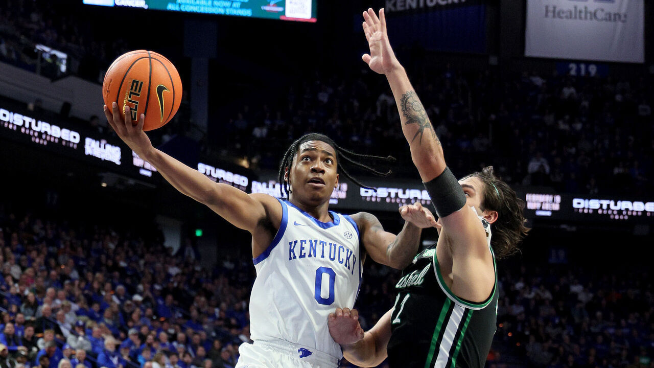 LEXINGTON, KENTUCKY - NOVEMBER 24: Rob Dillingham #0 of the Kentucky Wildcats shoots the ball while defended by Goran Miladinovic #21of the Marshall Thundering Herd in the second half at Rupp Arena on November 24, 2023 in Lexington, Kentucky.