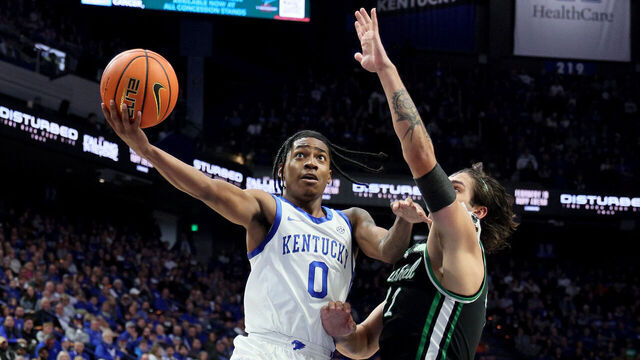 LEXINGTON, KENTUCKY - NOVEMBER 24: Rob Dillingham #0 of the Kentucky Wildcats shoots the ball while defended by Goran Miladinovic #21of the Marshall Thundering Herd in the second half at Rupp Arena on November 24, 2023 in Lexington, Kentucky.