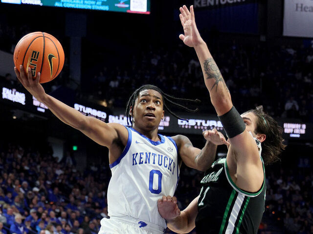 LEXINGTON, KENTUCKY - NOVEMBER 24: Rob Dillingham #0 of the Kentucky Wildcats shoots the ball while defended by Goran Miladinovic #21of the Marshall Thundering Herd in the second half at Rupp Arena on November 24, 2023 in Lexington, Kentucky.