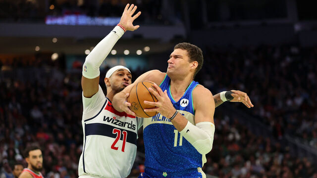 MILWAUKEE, WISCONSIN - NOVEMBER 24: Brook Lopez #11 of the Milwaukee Bucks drives to the basket against Daniel Gafford #21 of the Washington Wizards during the second half of an In-Season Tournament game at Fiserv Forum on November 24, 2023 in Milwaukee, Wisconsin.