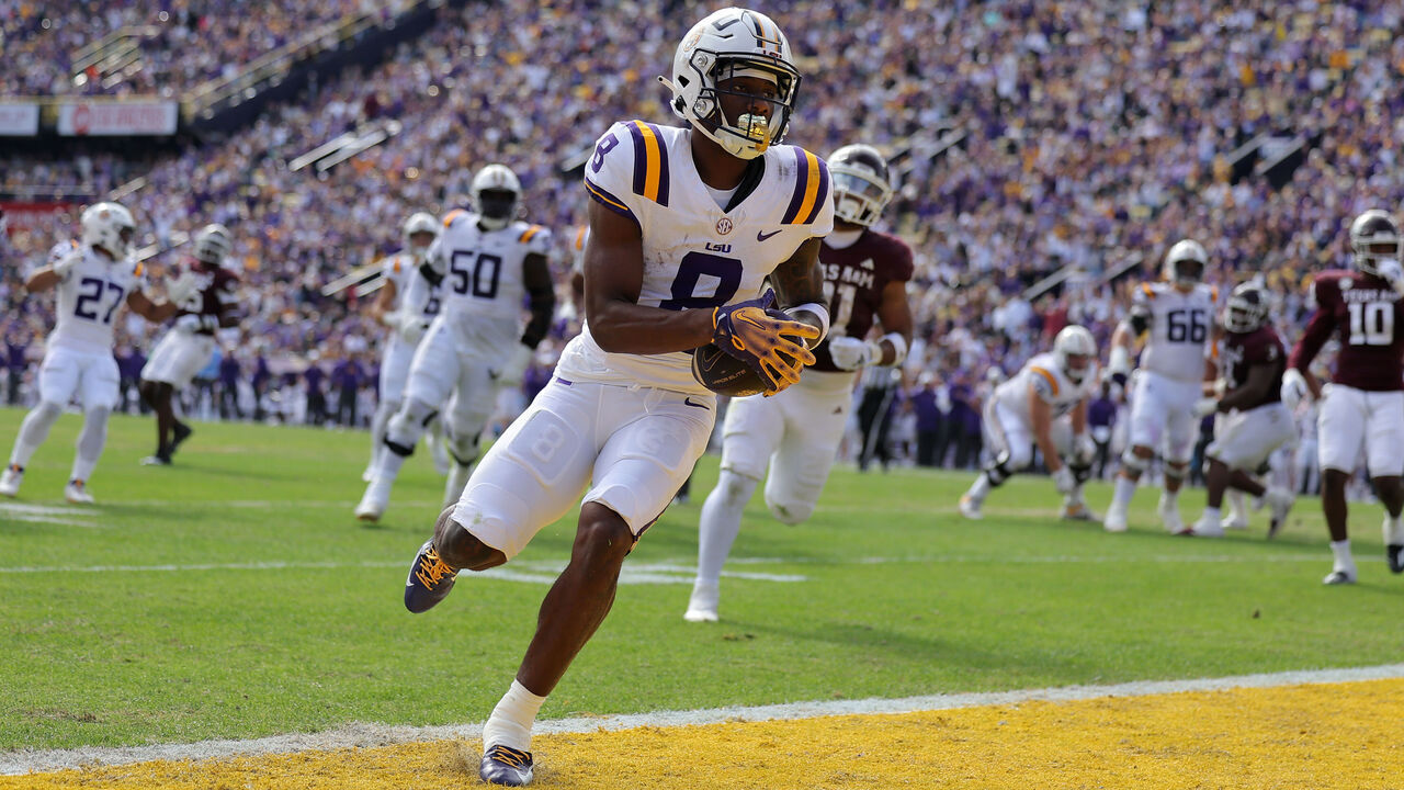BATON ROUGE, LOUISIANA - NOVEMBER 25: Malik Nabers #8 of the LSU Tigers scores a touchdown during the first half against the Texas A&M Aggies at Tiger Stadium on November 25, 2023 in Baton Rouge, Louisiana.