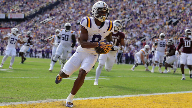 BATON ROUGE, LOUISIANA - NOVEMBER 25: Malik Nabers #8 of the LSU Tigers scores a touchdown during the first half against the Texas A&M Aggies at Tiger Stadium on November 25, 2023 in Baton Rouge, Louisiana.