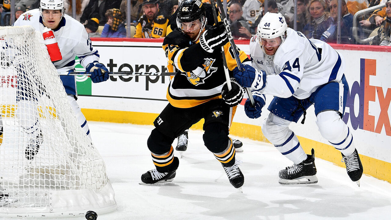 PITTSBURGH, PA - NOVEMBER 25: Erik Karlsson #65 of the Pittsburgh Penguins and Morgan Rielly #44 of the Toronto Maple Leafs battle at PPG PAINTS Arena on November 25, 2023 in Pittsburgh, Pennsylvania.