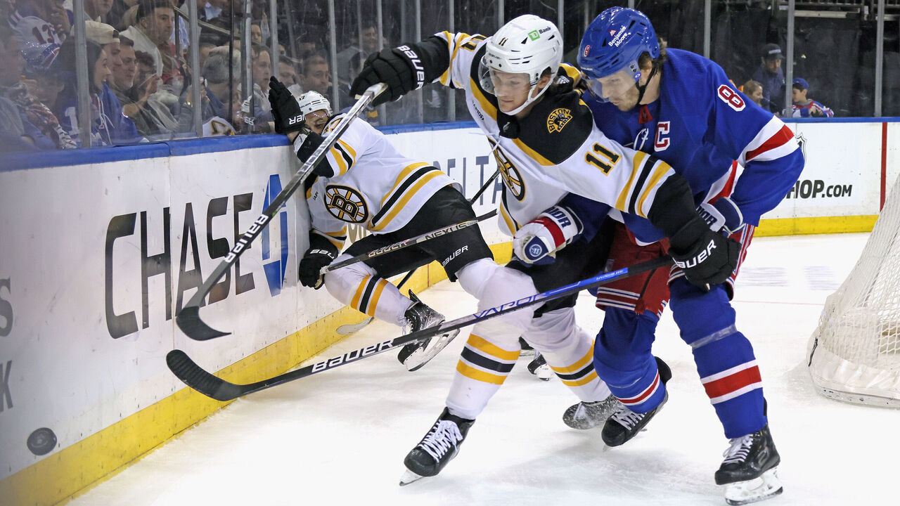NEW YORK, NEW YORK - JANUARY 19: Jacob Trouba #8 of the New York Rangers holds up Trent Frederic #11 of the Boston Bruins during the first period at Madison Square Garden on January 19, 2023 in New York City.
