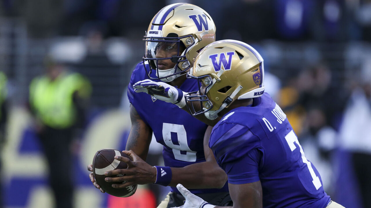SEATTLE, WA - November 25: Washington #9 (QB) Michael Penix Jr and #7 (RB) Dillon Johnson during the 115 Apple Cup college football game between the Washington Huskies and the Washington State Cougars on November 25, 2023, at Husky Stadium in Seattle, WA.