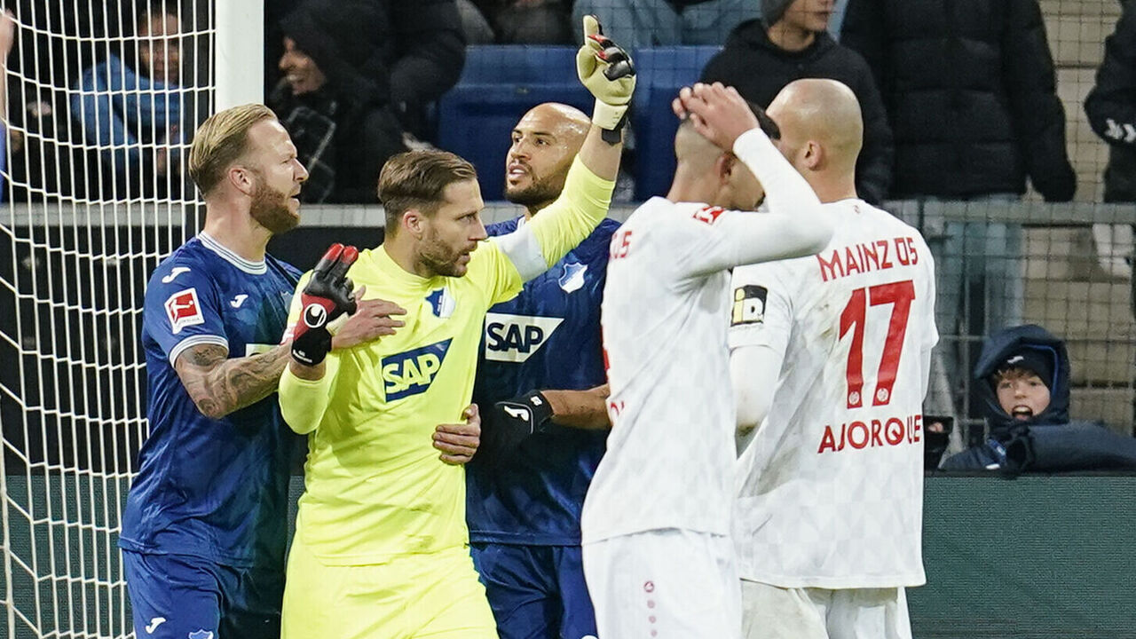 26 November 2023, Baden-Württemberg, Sinsheim: Soccer: Bundesliga, TSG 1899 Hoffenheim - FSV Mainz 05, Matchday 12, PreZero Arena. Hoffenheim goalkeeper Oliver Baumann celebrates with teammates after saving a penalty. Photo: Uwe Anspach/dpa - IMPORTANT NOTE: In accordance with the regulations of the DFL German Football League and the DFB German Football Association, it is prohibited to utilize or have utilized photographs taken in the stadium and/or of the match in the form of sequential images and/or video-like photo series.