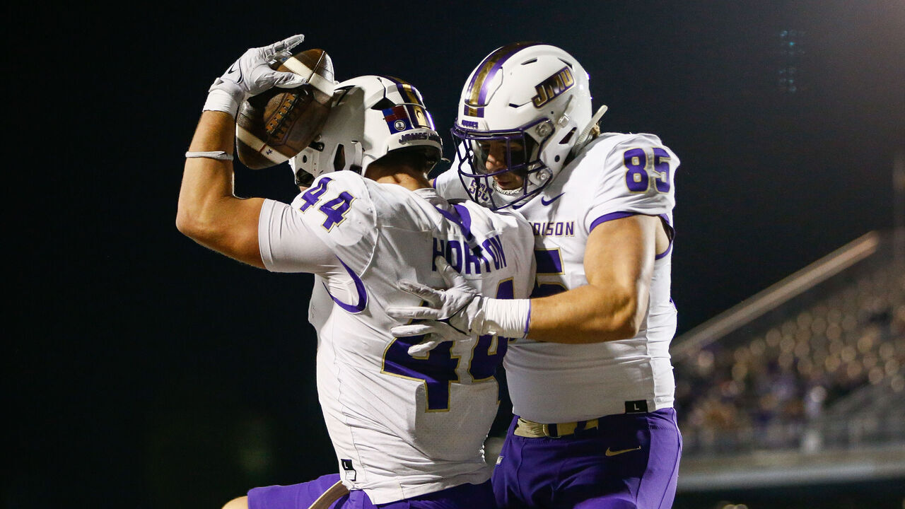CONWAY, SOUTH CAROLINA - NOVEMBER 25: Zach Horton #44 of the James Madison Dukes celebrates with Jordan Funk #85 of the James Madison Dukes after scoring a touchdown during the second half against the Coastal Carolina Chanticleers at Brooks Stadium on November 25, 2023 in Conway, South Carolina.