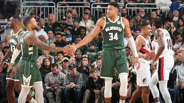 MILWAUKEE, WI - NOVEMBER 26: Damian Lillard #0 and Giannis Antetokounmpo #34 of the Milwaukee Bucks high five during the game against the Portland Trail Blazers on November 26, 2023 at the Fiserv Forum Center in Milwaukee, Wisconsin. Mandatory Copyright Notice: Copyright 2023 NBAE .