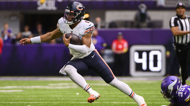 MINNEAPOLIS, MN - OCTOBER 09: Justin Fields #1 of the Chicago Bears scrambles with the ball in the fourth quarter of the game against the Minnesota Vikings at U.S. Bank Stadium on October 9, 2022 in Minneapolis, Minnesota. The play was ruled a touchdown, but was called back due to a penalty on the offense.