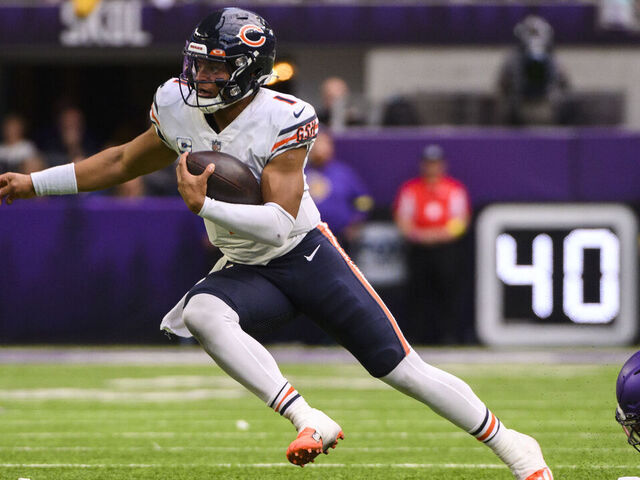 MINNEAPOLIS, MN - OCTOBER 09: Justin Fields #1 of the Chicago Bears scrambles with the ball in the fourth quarter of the game against the Minnesota Vikings at U.S. Bank Stadium on October 9, 2022 in Minneapolis, Minnesota. The play was ruled a touchdown, but was called back due to a penalty on the offense.