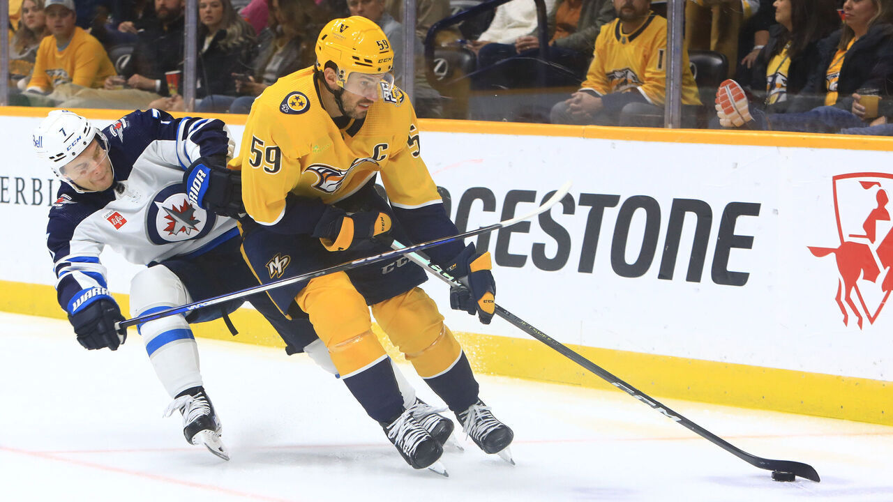 NASHVILLE, TN - NOVEMBER 26: Nashville Predators defenseman Roman Josi (59) shields the puck from Winnipeg Jets center Vladislav Namestnikov (7) during the NHL game between the Nashville Predators and Winnipeg Jets, held on November 26, 2023, at Bridgestone Arena in Nashville, Tennessee.
