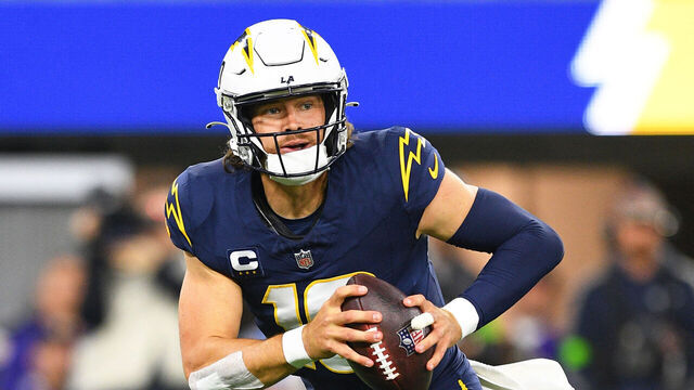 INGLEWOOD, CA - NOVEMBER 26: Los Angeles Chargers quarterback Justin Herbert (10) rolls out during the NFL regular season game between the Baltimore Ravens and the Los Angeles Chargers on November 26, 2023, at SoFi Stadium in Inglewood, CA.