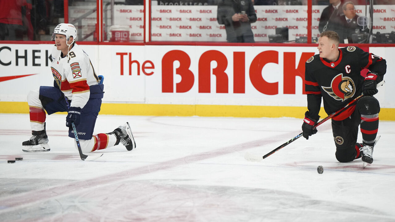OTTAWA, CANADA - MARCH 27: Brothers Brady Tkachuk #7 of the Ottawa Senators and Matthew Tkachuk #19 of the Florida Panthers stretch at centre ice during warm-up prior to a game at Canadian Tire Centre on March 27, 2023 in Ottawa, Ontario, Canada.