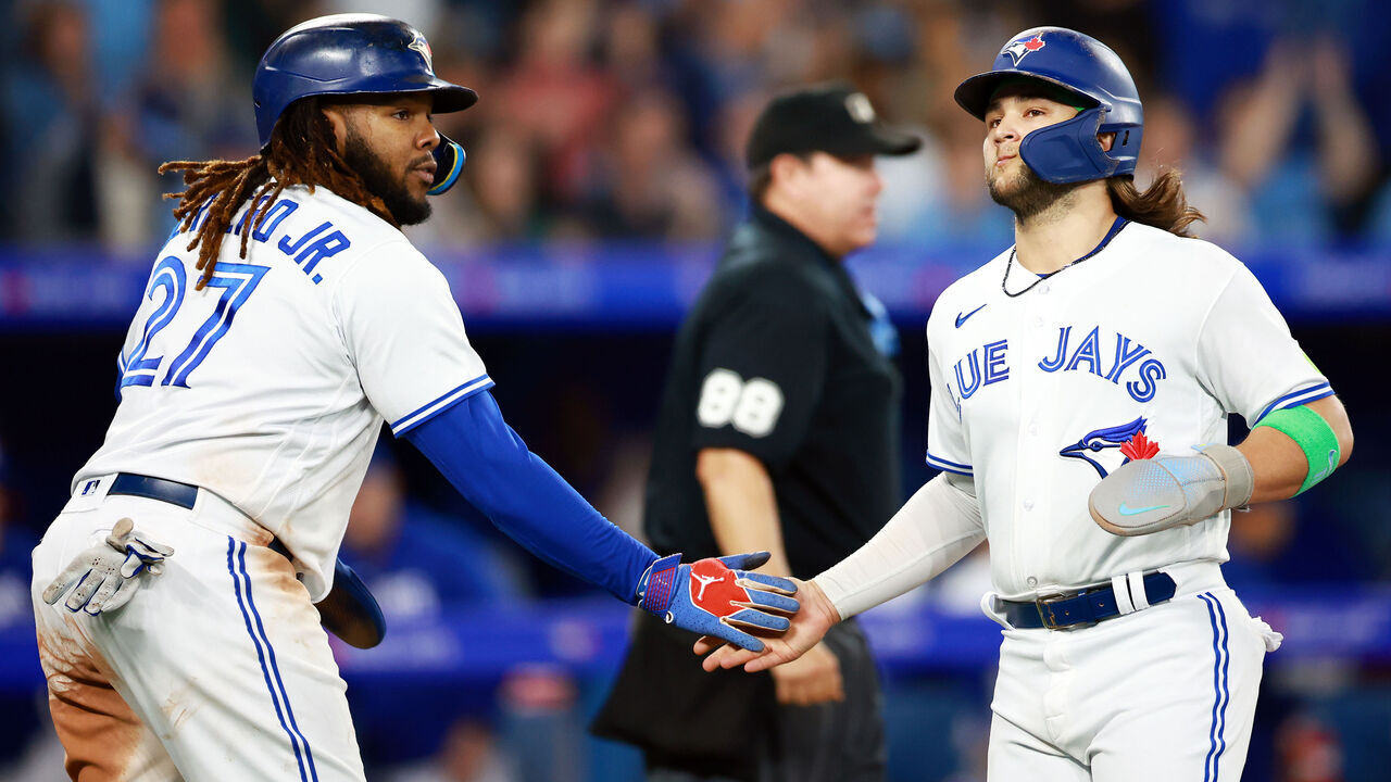 TORONTO, ON - SEPTEMBER 29: Vladimir Guerrero Jr. #27 celebrates with Bo Bichette #11 of the Toronto Blue Jays after scoring on a two RBI single by Cavan Biggio #8 in the sixth inning against the Tampa Bay Rays at Rogers Centre on September 29, 2023 in Toronto, Ontario, Canada.