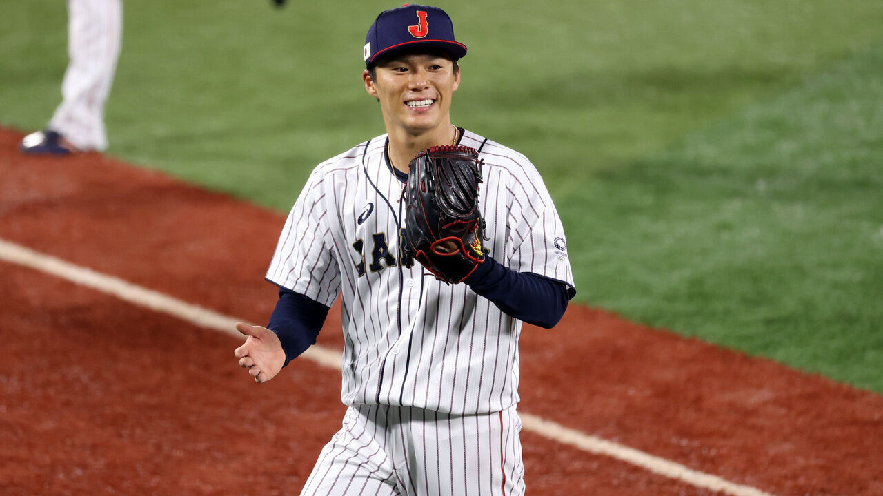 YOKOHAMA, JAPAN - AUGUST 04: Yoshinobu Yamamoto #17 of Team Japan reacts as he walks back to the dugout against Team Republic of Korea during the semifinals of men's baseball on day twelve of the Tokyo 2020 Olympic Games at Yokohama Baseball Stadium on August 04, 2021 in Yokohama, Japan.