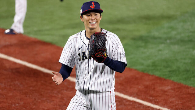 YOKOHAMA, JAPAN - AUGUST 04: Yoshinobu Yamamoto #17 of Team Japan reacts as he walks back to the dugout against Team Republic of Korea during the semifinals of men's baseball on day twelve of the Tokyo 2020 Olympic Games at Yokohama Baseball Stadium on August 04, 2021 in Yokohama, Japan.