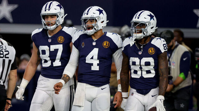 ARLINGTON, TEXAS - NOVEMBER 23: Dak Prescott #4 and CeeDee Lamb #88 of the Dallas Cowboys celebrates after a touchdown with Jake Ferguson #87 in the game against the Washington Commanders during the third quarter at AT&T Stadium on November 23, 2023 in Arlington, Texas.